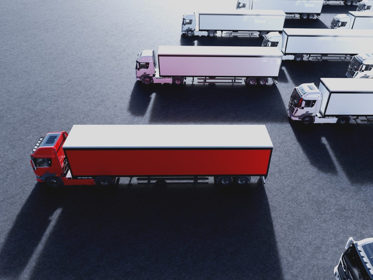 Fleet of new heavy trucks with one selected. Transportation